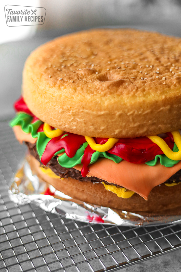 Piece Of The Burger Cake, Madeira And Chocolate Sponge Layered Cake, Filled  With Frosting Covered With Soft Icing And Edible Sugar Decorations, Cake In  The Shape Burger Stock Photo, Picture And Royalty