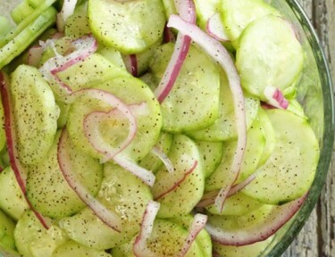 Overhead view of Easy Vinegar Marinated Cucumbers in a glass bowl.