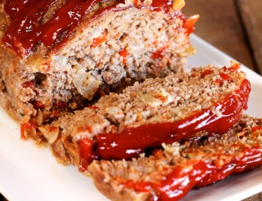 Claim Jumper Meatloaf with a couple slices on the end topped with a garnish.