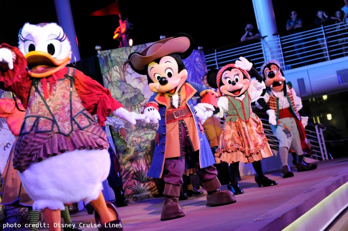 Mickey Mouse, Minnie, Goofy, and Daisy on stage dancing in pirate clothes. 