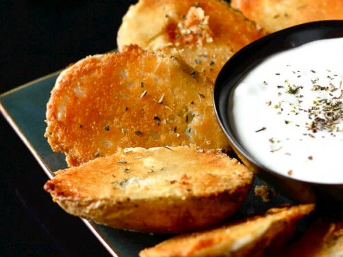 Parmesan Baked Potato Halves with a side of Sour Cream