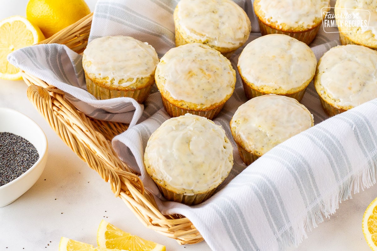 Basket full of Lemon Poppy Seed Muffins with a white glaze.