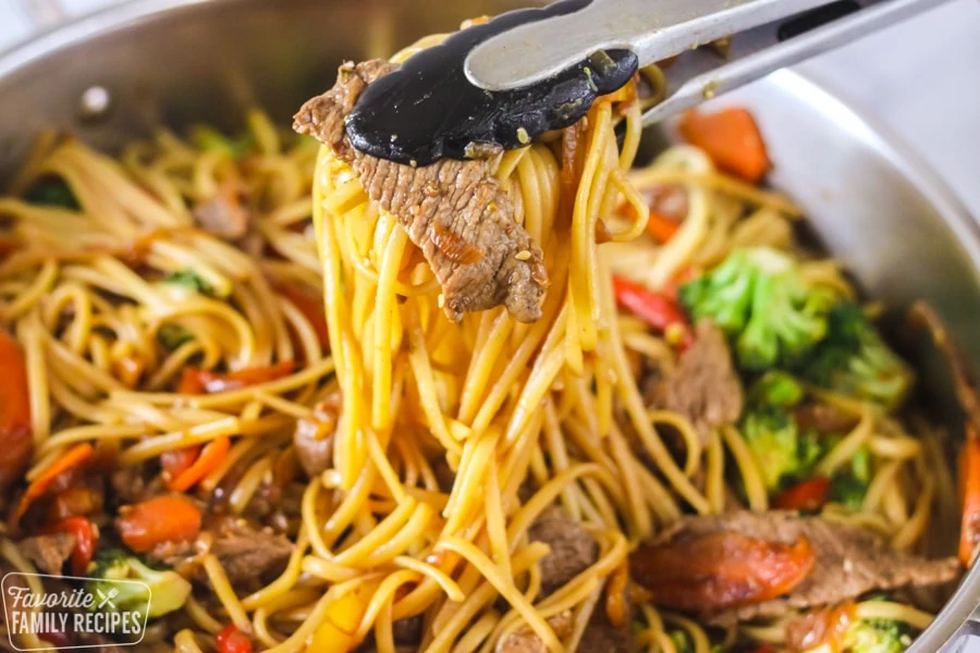 Beef Stir Fry being served with tongs