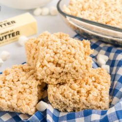 Microwave rice krispie treats stacked on a top of each other.