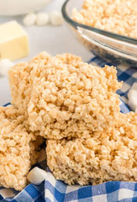 Microwave rice krispie treats stacked on a top of each other.