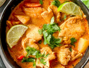 Chicken Massaman Curry in a black bowl.