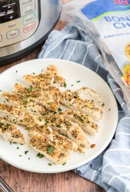 Sliced chicken on a plate with an instant pot and a bag of frozen chicken in the background