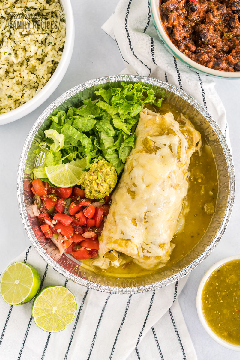 A homemade cafe rio sweet pork burrito with lettuce and pico de gallo