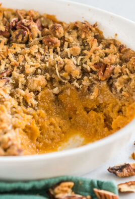 Side view of a sweet potato casserole with a scoop taken out