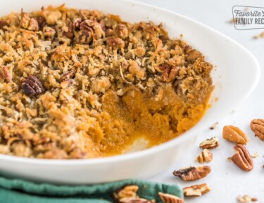 Side view of a sweet potato casserole with a scoop taken out