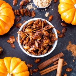 Pumpkin seeds that have been roasted in a sweet and spicy mixture in a bowl