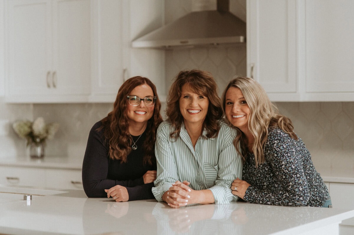 Emily, Echo, and Erica owners and authors of Favorite Family Recipes in a kitchen together