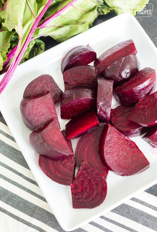 Sliced roasted red beets on a plate.