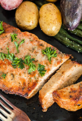 A top view of a pork chop made in the air fryer on a plate with vegetables