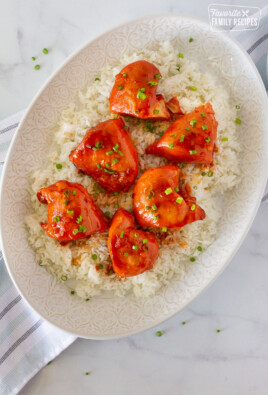 Full platter of Instant Pot Apricot Chicken topped with green onions and served over rice.