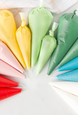 Red, pink, yellow, light green, dark green, blue and white bags of Royal Icing.