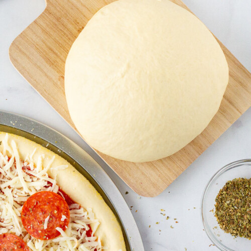 https://www.favfamilyrecipes.com/wp-content/uploads/2022/12/Unbaked-pizza-with-Homemade-Pizza-Dough-500x500.jpg