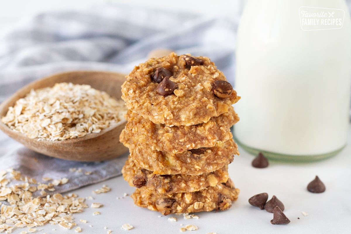 Healthy Oatmeal Cookies stacked up with a glass of milk.