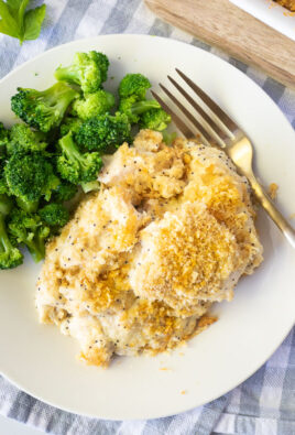 Plate of Poppy Seed Chicken with cooked broccoli and a fork.