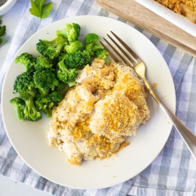 Plate of Poppy Seed Chicken with cooked broccoli and a fork.