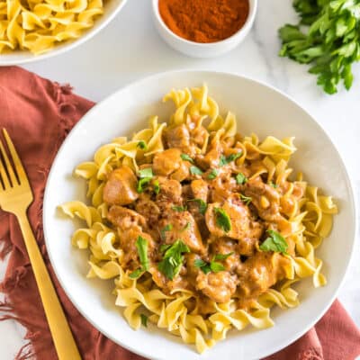 Chicken Paprikash in a bowl topped with parsley