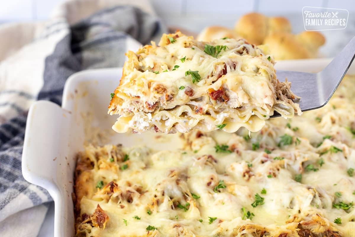 Premium Photo  Woman holding spatula with piece of spinach lasagna over  baking dish