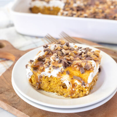 Pumpkin Poke Cake slice on a plate.