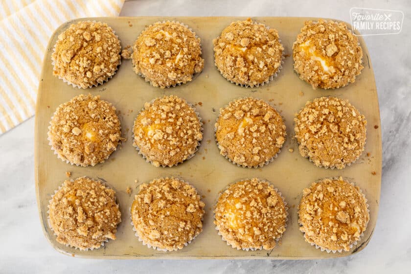 Baked Pumpkin Cream Cheese Muffins in a muffin pan.