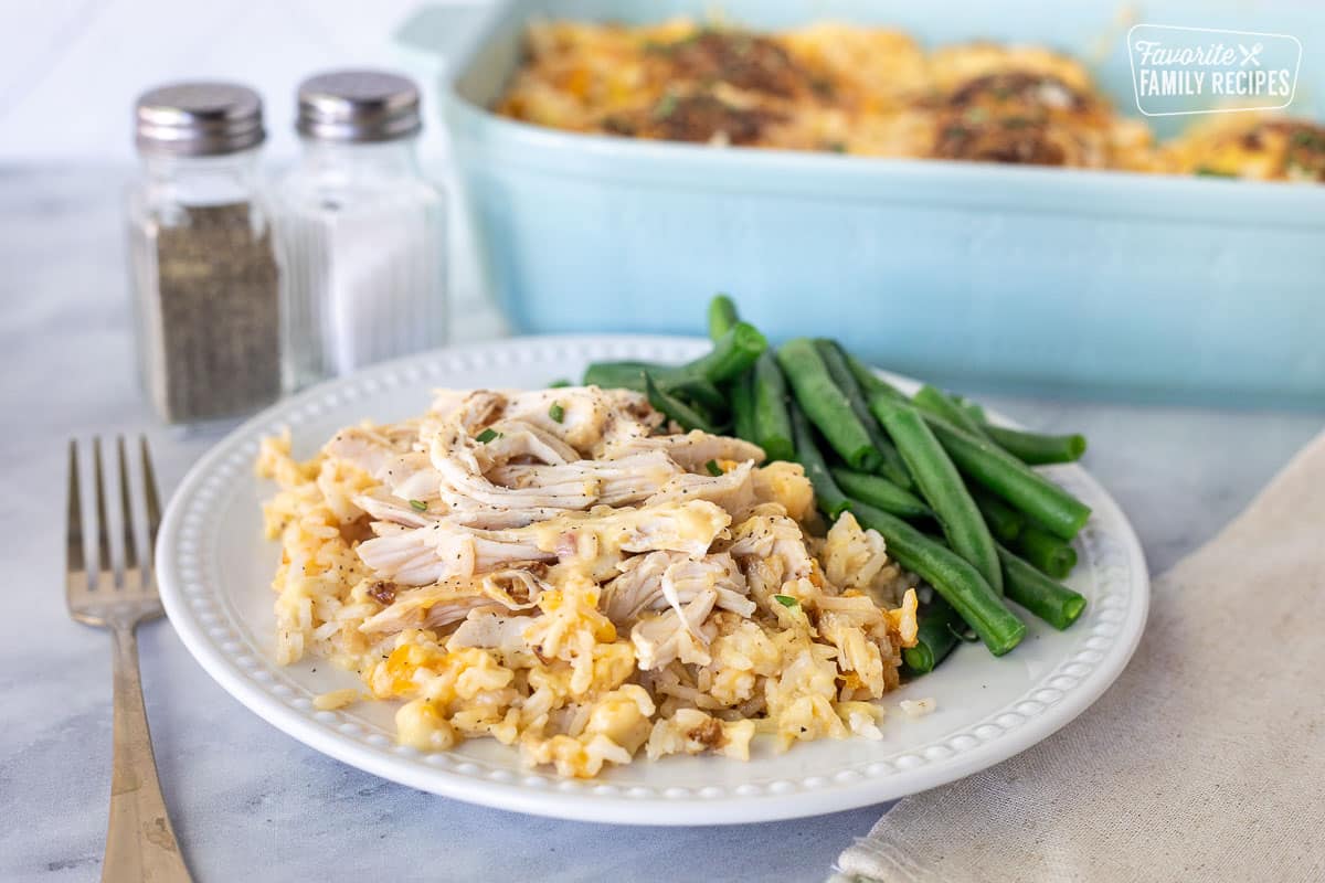 Plate with Cheesy Chicken and Rice Casserole with green beans.