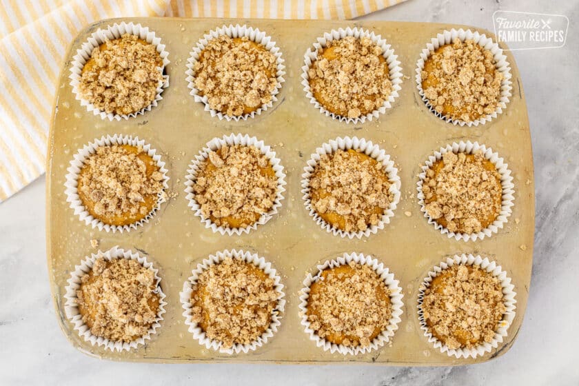 Streusel topping on top of unbaked Pumpkin Cream Cheese Muffins.