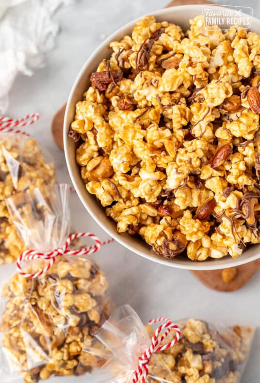 Bowl of Moose Munch Popcorn with bags of Moose Munch Popcorn on the side.