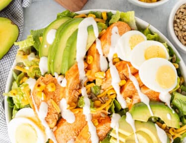 Buffalo Chicken Salad in a bowl with creamy Ranch dressing on top.