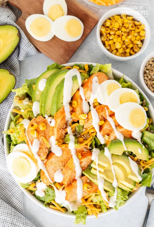 Buffalo Chicken Salad in a bowl with creamy Ranch dressing on top.