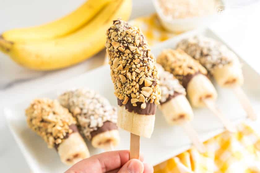 A banana dipped in chocolate and rolled in peanuts