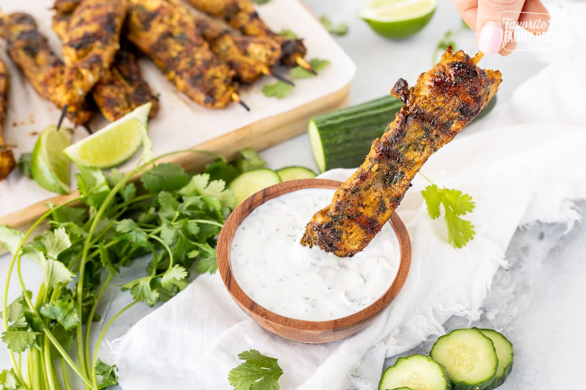 Dipping Thai chicken skewers with cucumber yogurt dip.