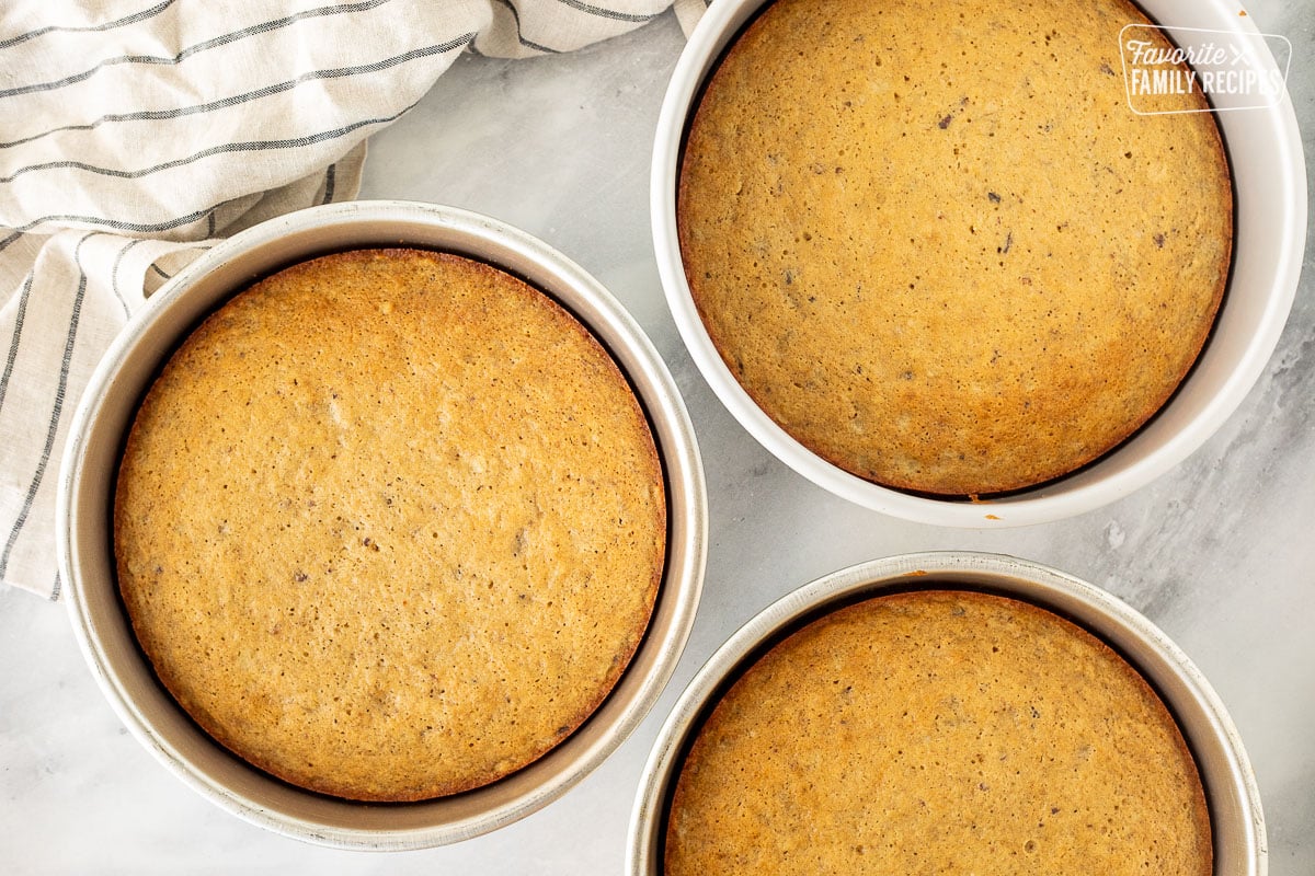 Three cake pans with baked Hummingbird cake.