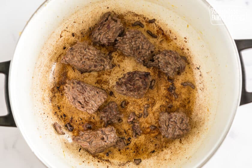 Seared chunks of ground beef in a pan