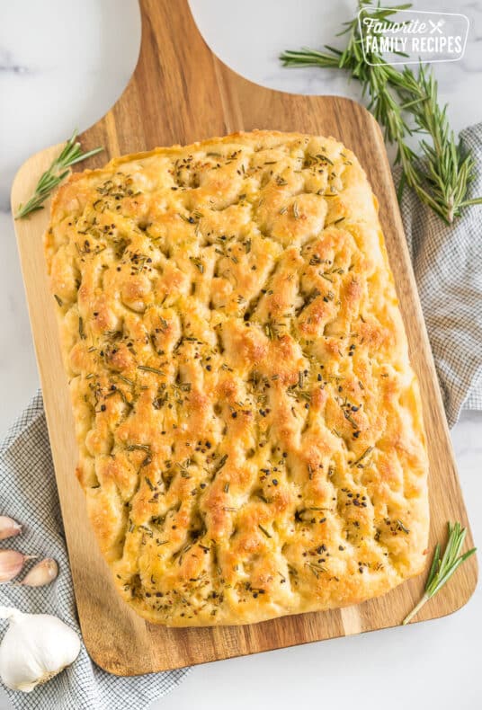 A loaf of Rosemary Garlic Focaccia Bread on a cutting board