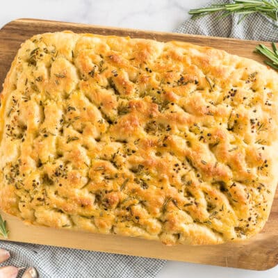 A loaf of Rosemary Garlic Focaccia Bread on a cutting board