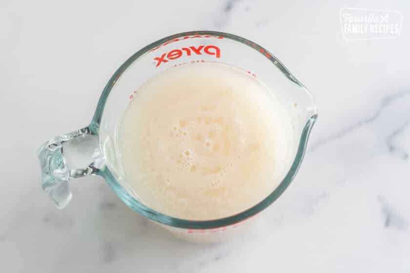 Bloomed yeast in a glass measuring cup.