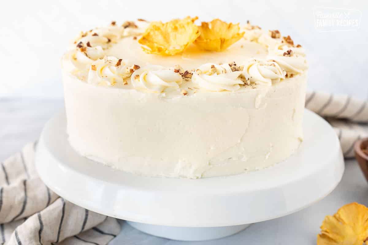 Whole Hummingbird Cake on a cake Stand. Topped with dried pineapple flowers.