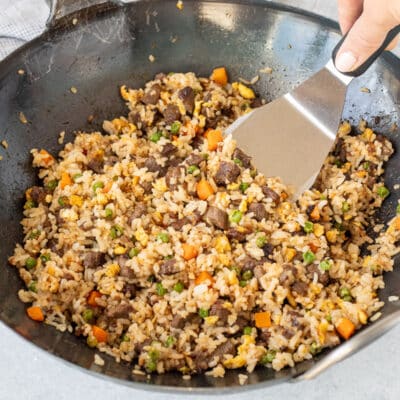 Scooping Steak Fried Rice out of wok.