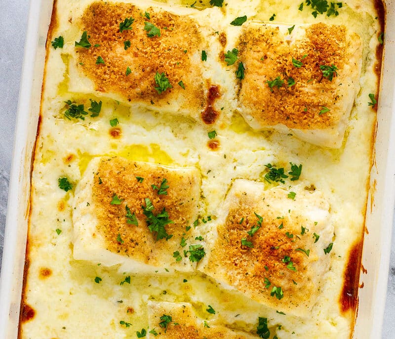 Baking dish with five pieces of of Baked Cod in Cream Sauce.