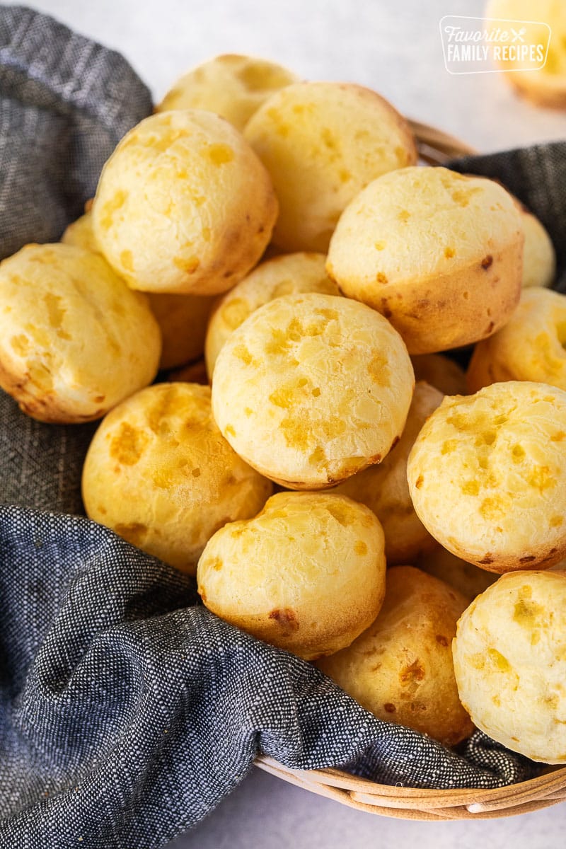 Golden Brazilian cheese bread rolls in a basket