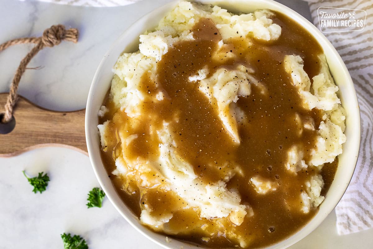 Large bowl of Mashed Potatoes with beef gravy on top.