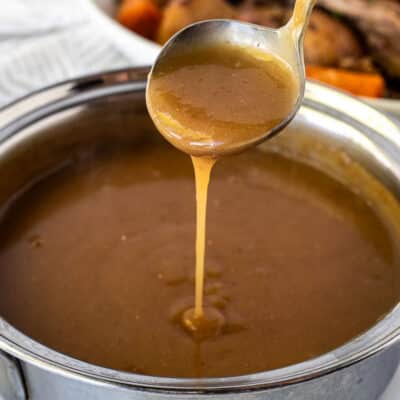 Ladle of Beef Gravy pouring into saucepan.