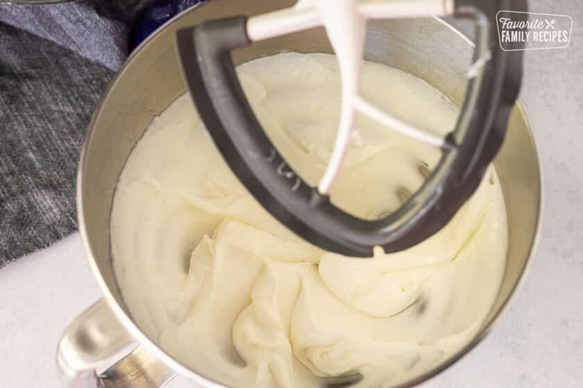 Stand mixer with paddle attachment and smooth white dough base.