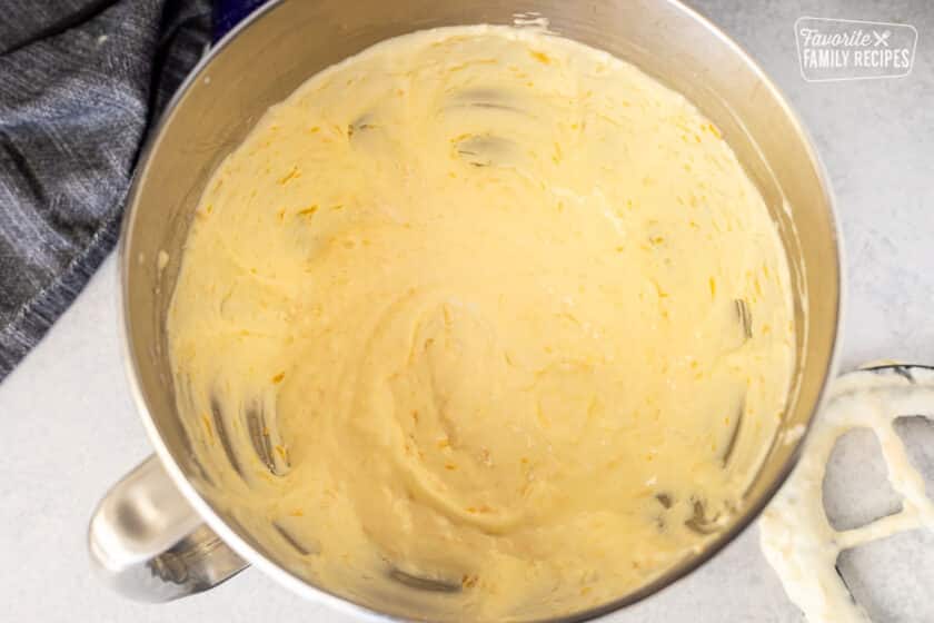 Brazilian Cheese Bread dough in a mixer bowl with paddle on the side.