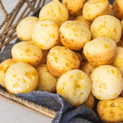 Baked Brazilian Cheese Bread in a basket with a linen.