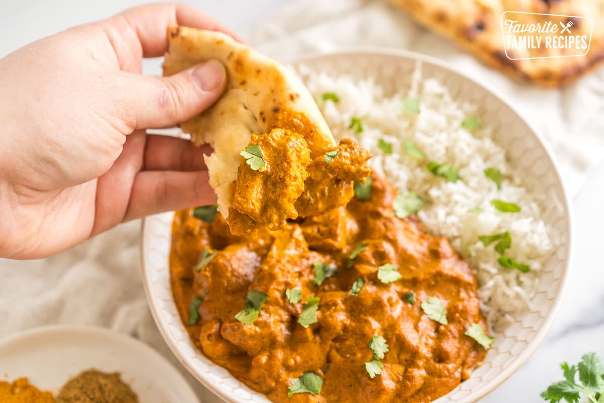 Naan bread dipped in butter chicken